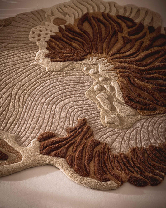 Brown beige rug close-up showing raised botanical pattern and textured surface