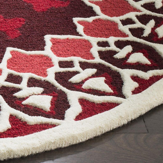 Red round carpet close-up showing burgundy red and cream ornamental medallion pattern