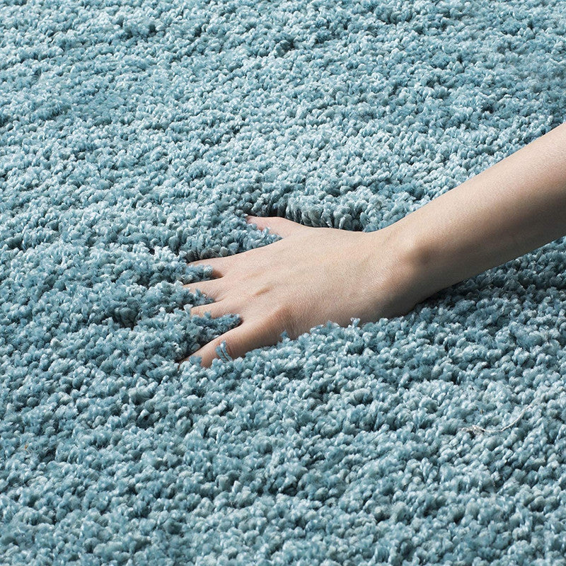 Aqua blue shaggy rug close-up showing dense plush textured pile