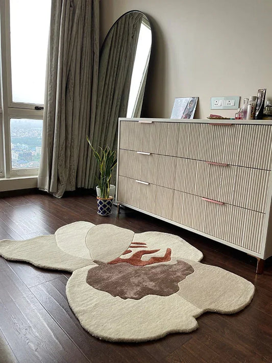 Asymmetric rug with cream base and brown and rust abstract design styled in a modern room