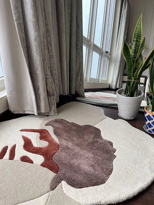 Asymmetric rug with irregular organic shape and abstract brown and rust pattern
