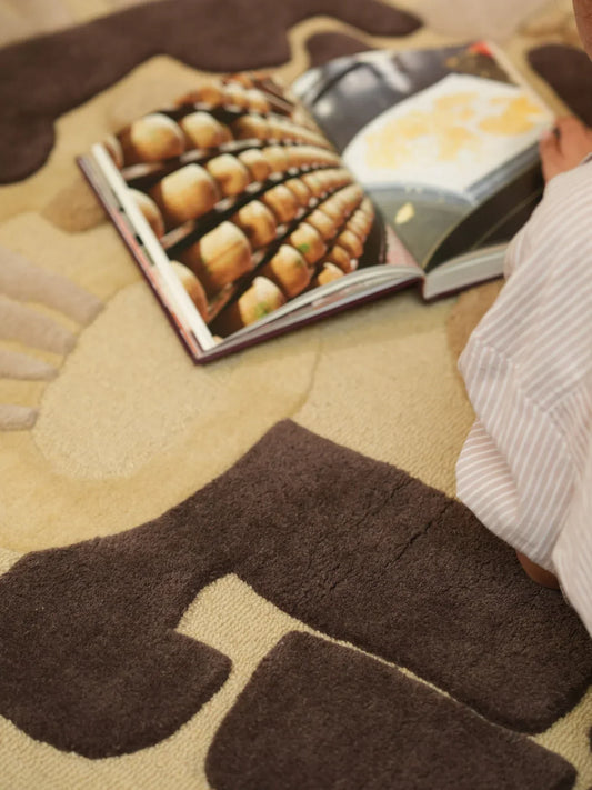 Close-up of beige and brown high-low texture on a hand-tufted wool carpet