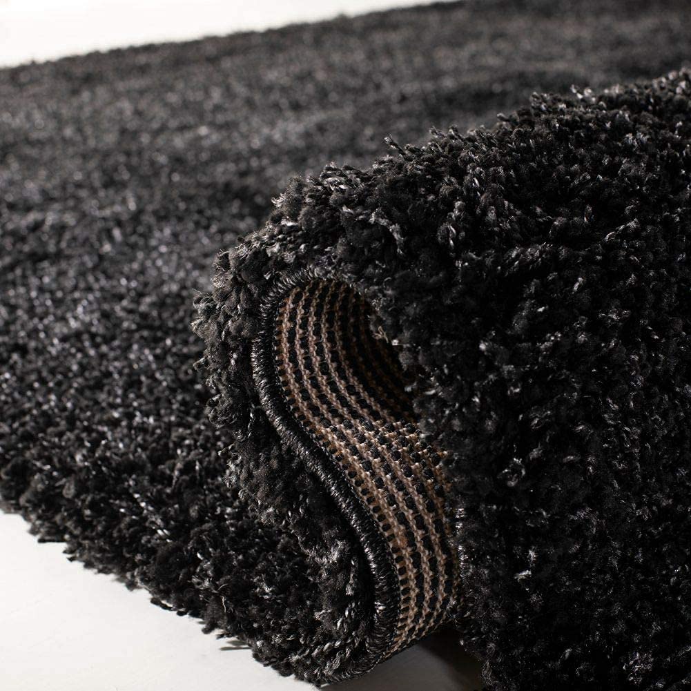 Black carpet showing shaggy surface and rug backing detail