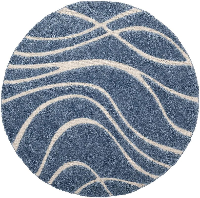 Round blue and white shaggy rug with abstract flowing line pattern