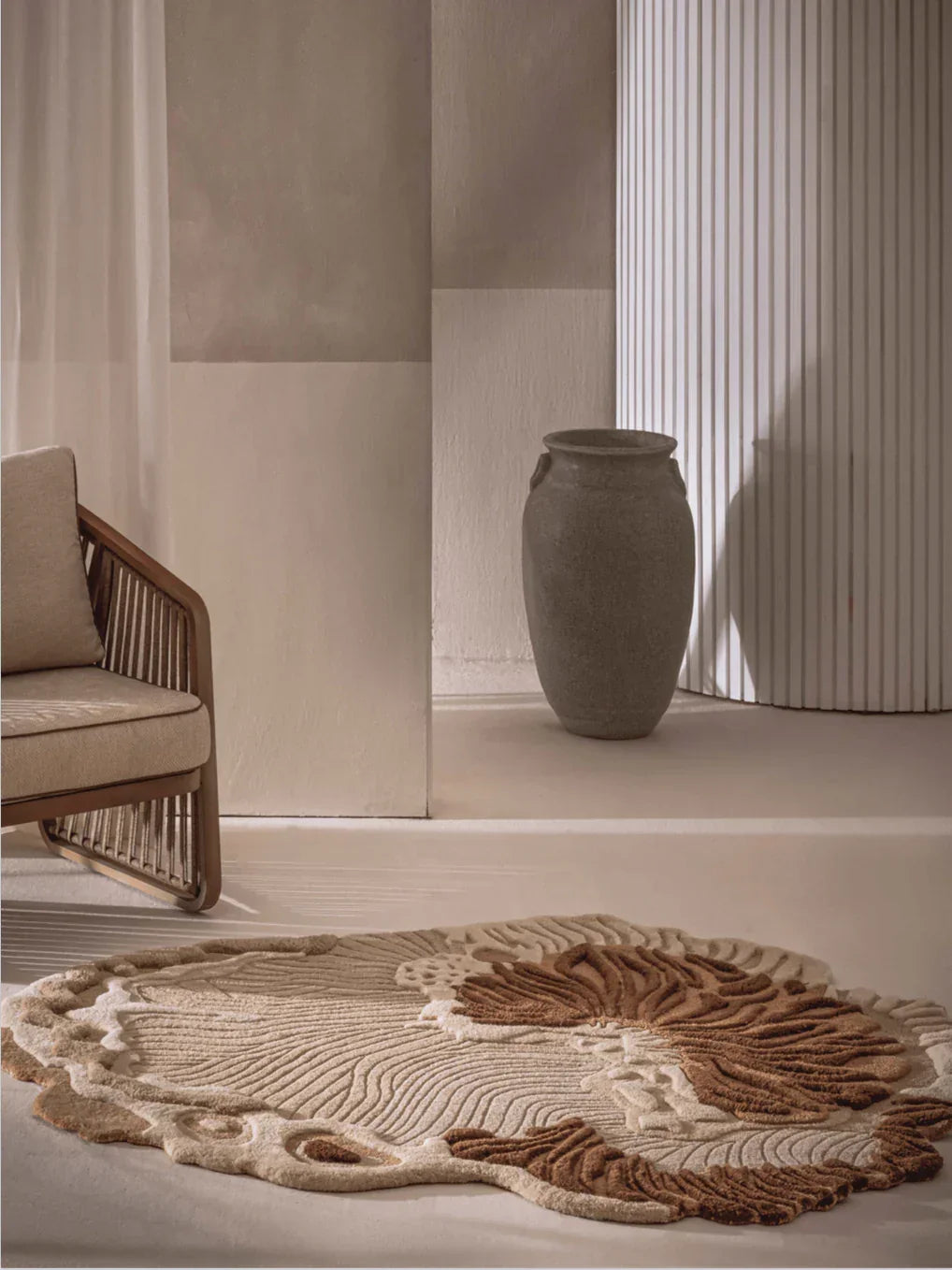 Brown beige rug with raised botanical design and organic shape styled in a modern living room