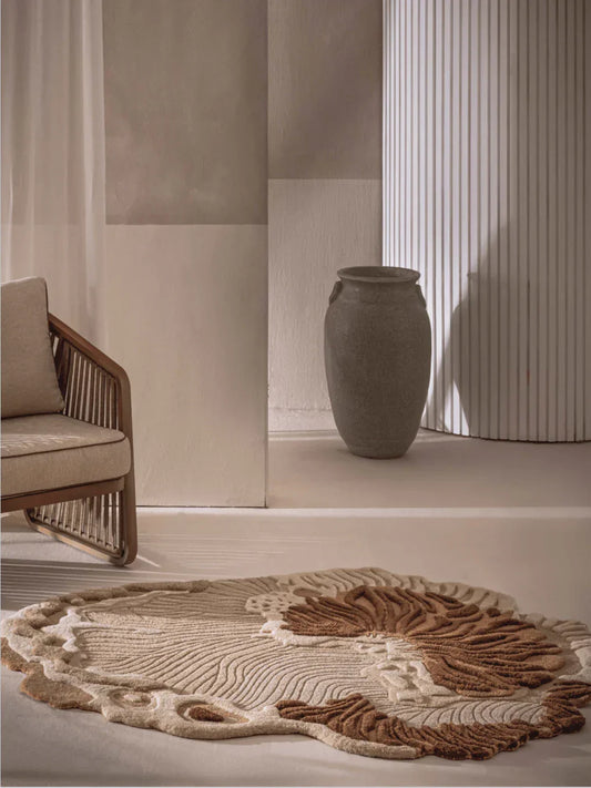 Brown beige rug with raised botanical design and organic shape styled in a modern living room