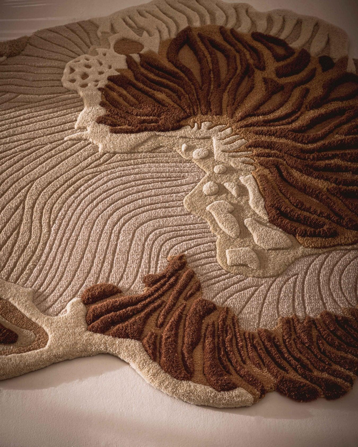 Brown beige rug close-up showing raised botanical pattern and textured surface
