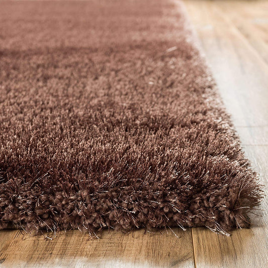 Dark brown shaggy carpet showing thick plush pile and textured fibers