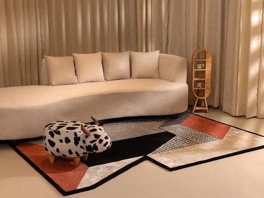 Freeform rug in black beige cream and rust geometric design styled in a modern living room