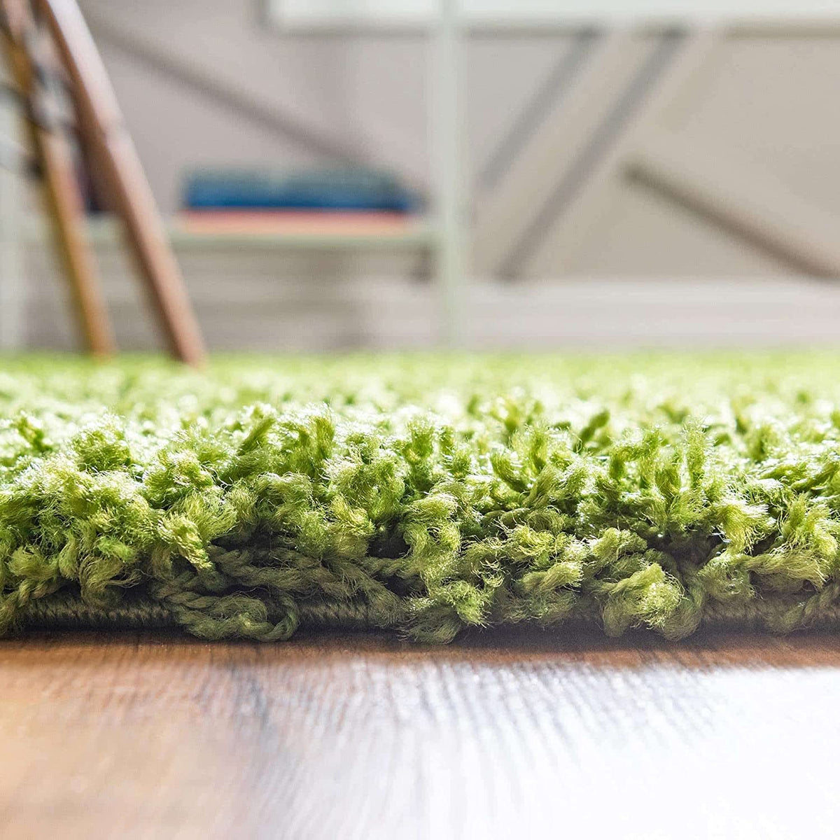 Green shaggy carpet close-up showing dense textured green pile