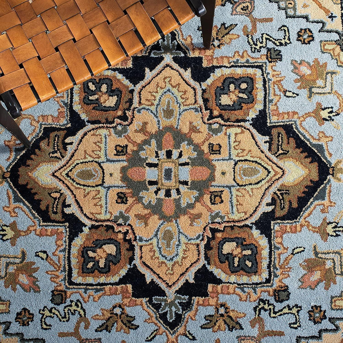 Persian Tabriz rug in blue and beige with traditional floral pattern in a living room