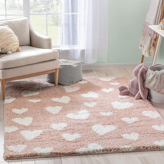 Pink heart carpet with blush pink shaggy texture and white heart pattern in a kids room