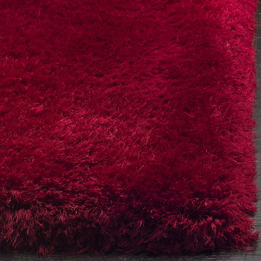 Red carpet close-up showing dense deep red shaggy polyester texture