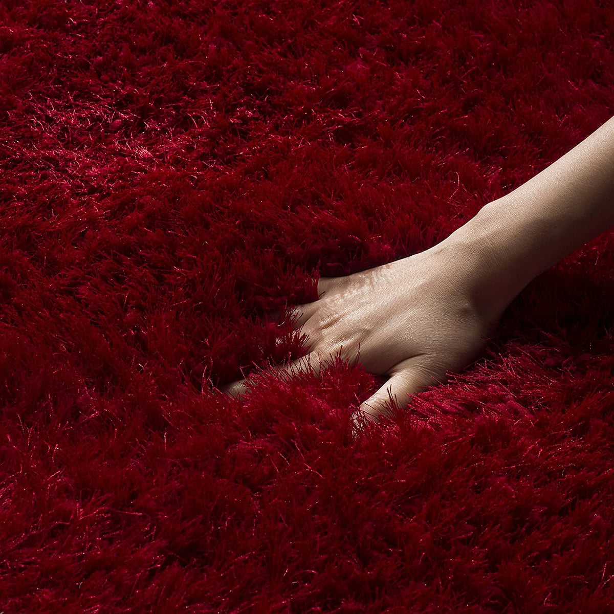 Red shaggy carpet showing dense plush deep red pile and textured surface