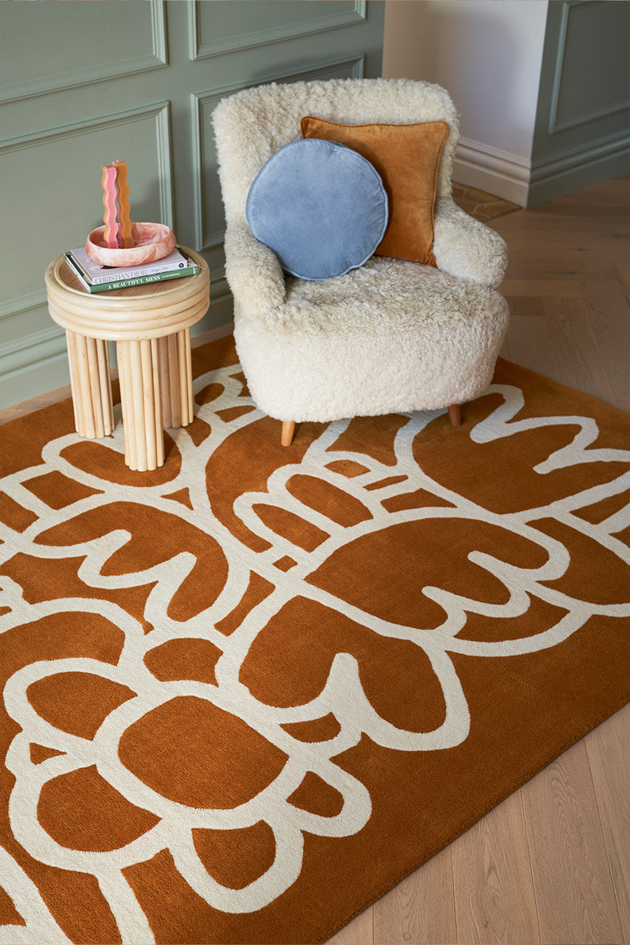Rust-orange squiggle rug with an ivory abstract pattern styled in a modern living room