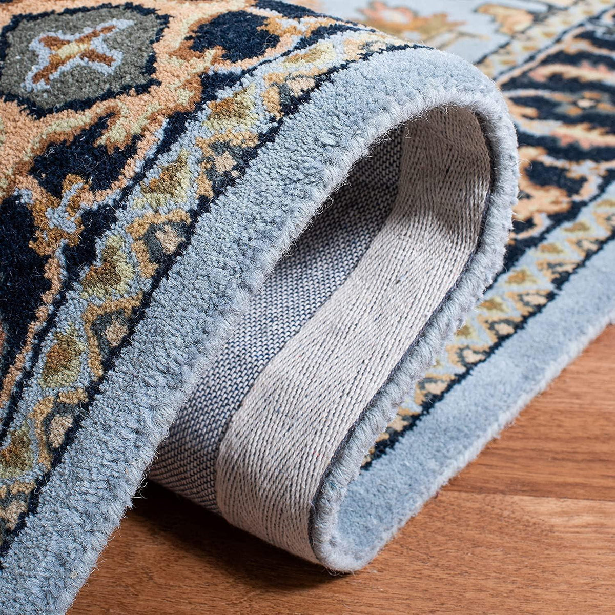Tabriz Persian carpet showing blue beige tufted construction and patterned border